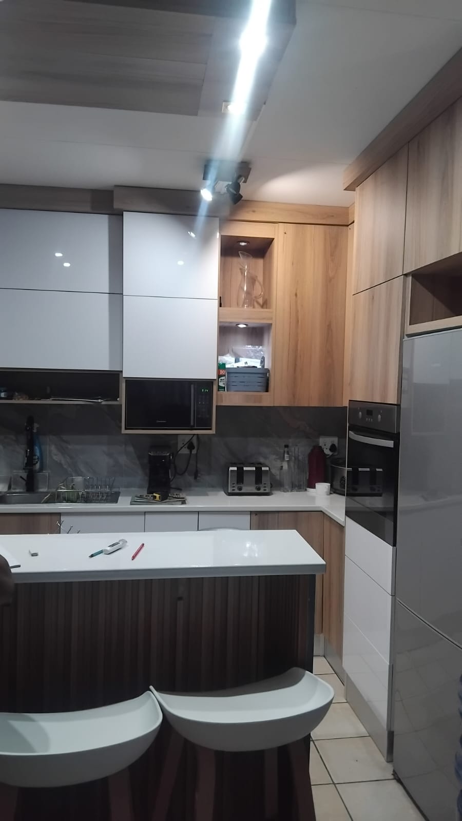 Supplied project: wood-look kitchen cabinetry and curved island